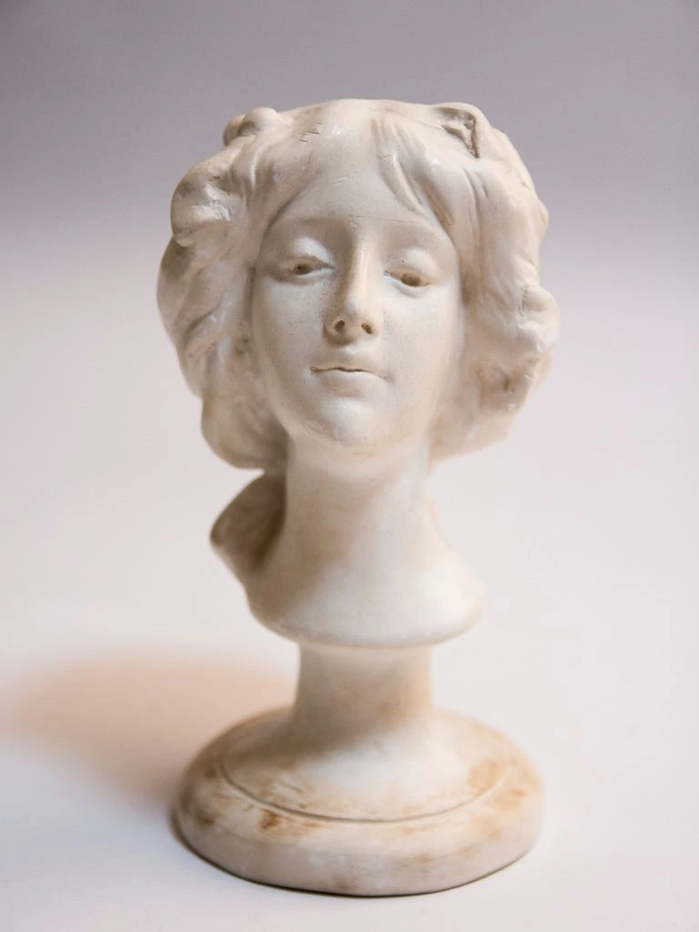 Small classical female bust carved in white Carrara marble on a wooden socle