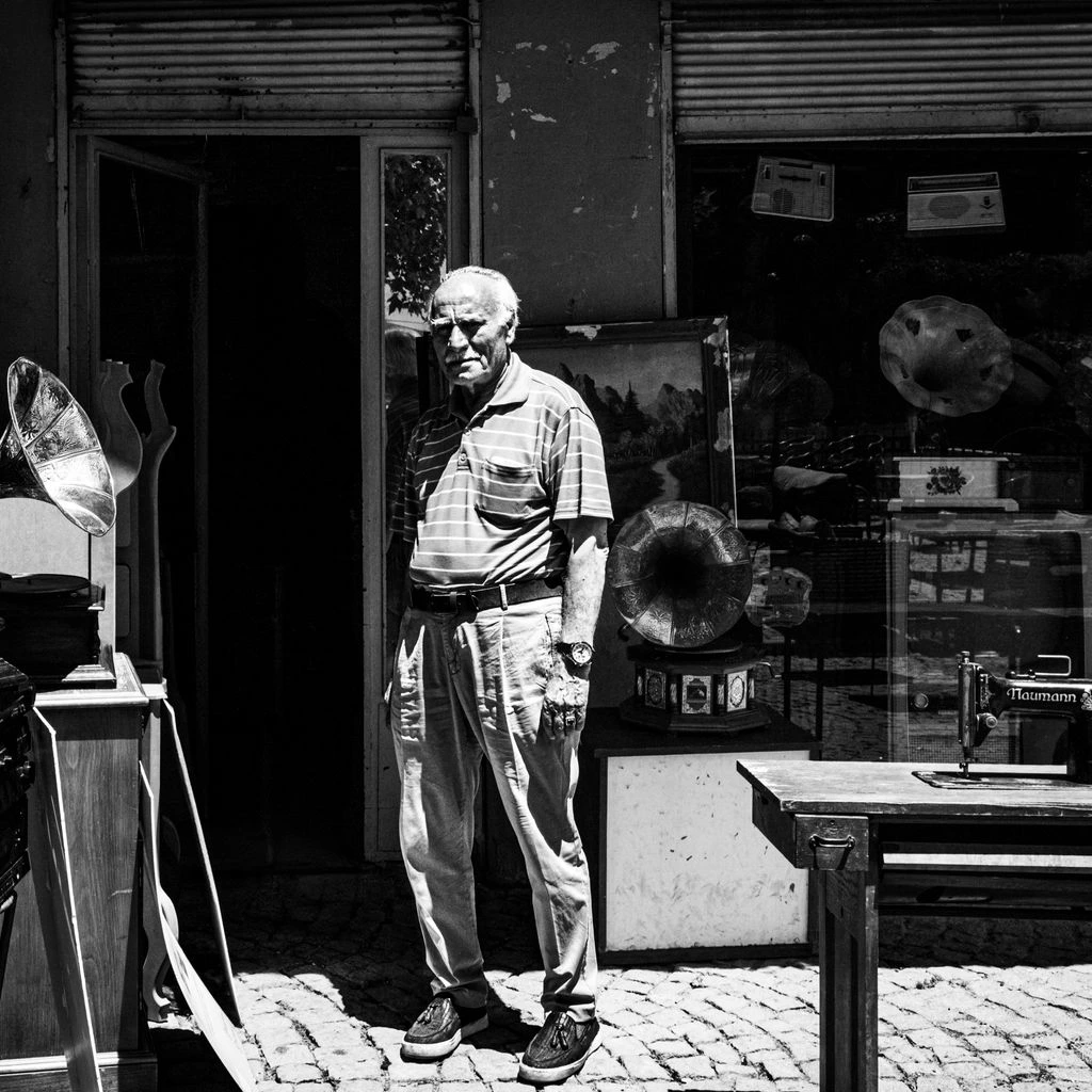 Portrait of a French antique dealer in her Lyon shop.
